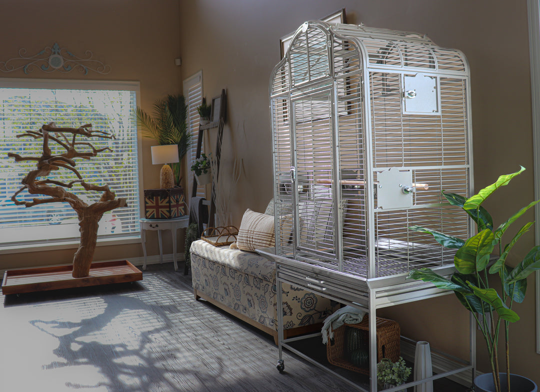 Large white parrot cage in a modern living room with natural light, next to a Java tree stand and cozy seating area — Squawk Shop bird setup inspiration