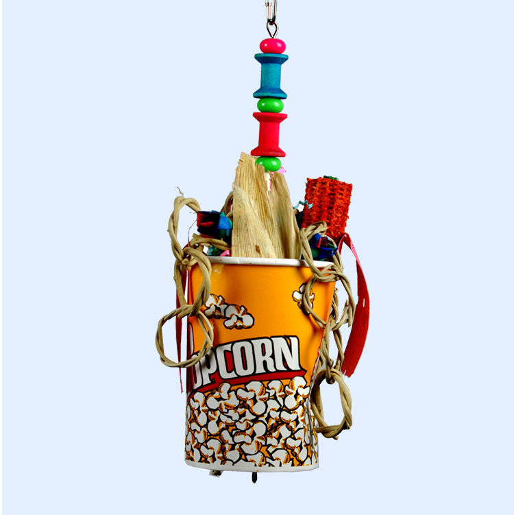 Movie Time Bird Toy from Squawk Shop, featuring a popcorn-themed cup filled with chewable wood, corn husks, and shreddable textures for birds to forage and explore.