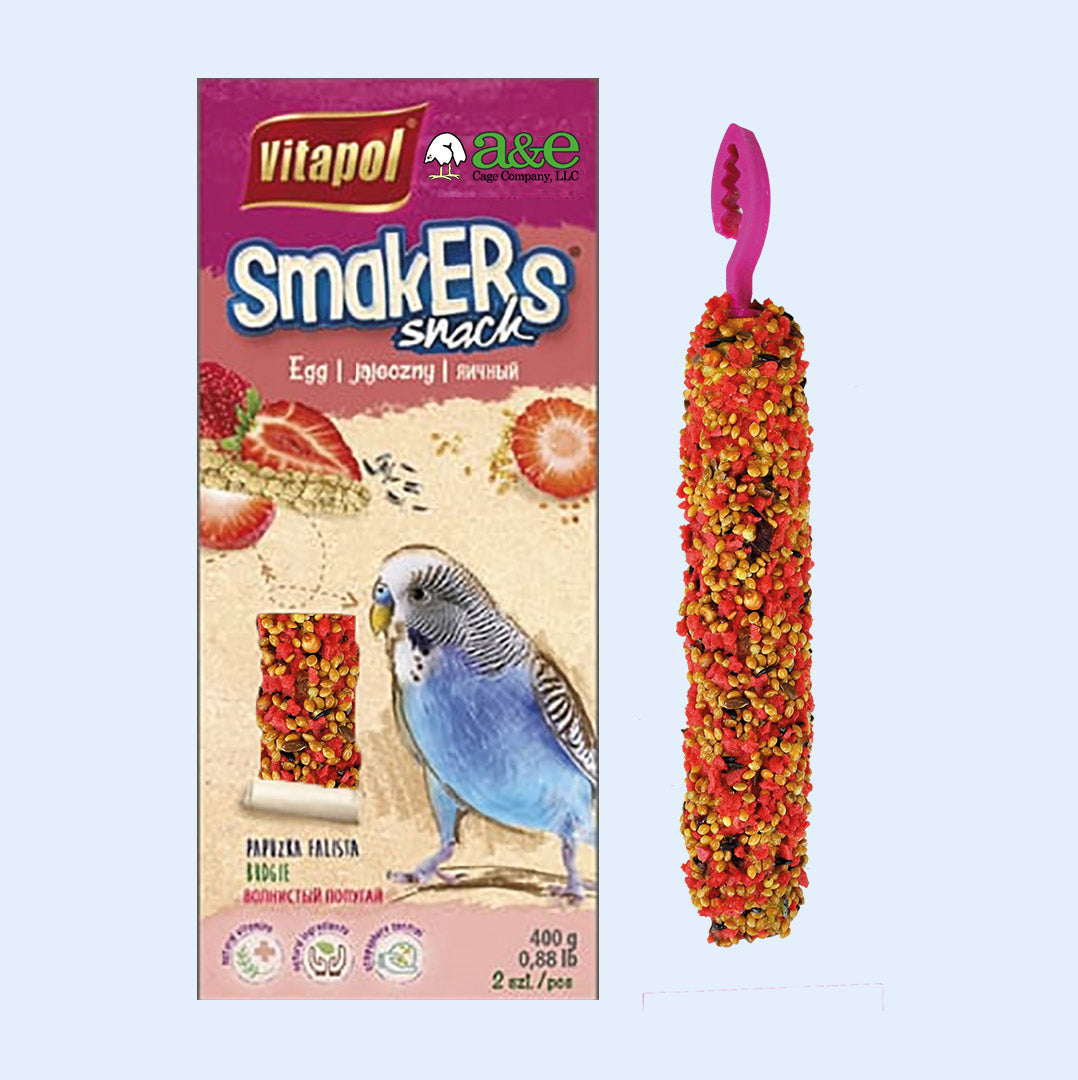 A box of Vitapol Smakers Snack treat sticks for parakeets, featuring strawberry flavor. The packaging includes a vibrant image of a blue parakeet, strawberries, and seeds, alongside a close-up of one treat stick with a colorful seed coating and a plastic hanger. Available at Squawk Shop.