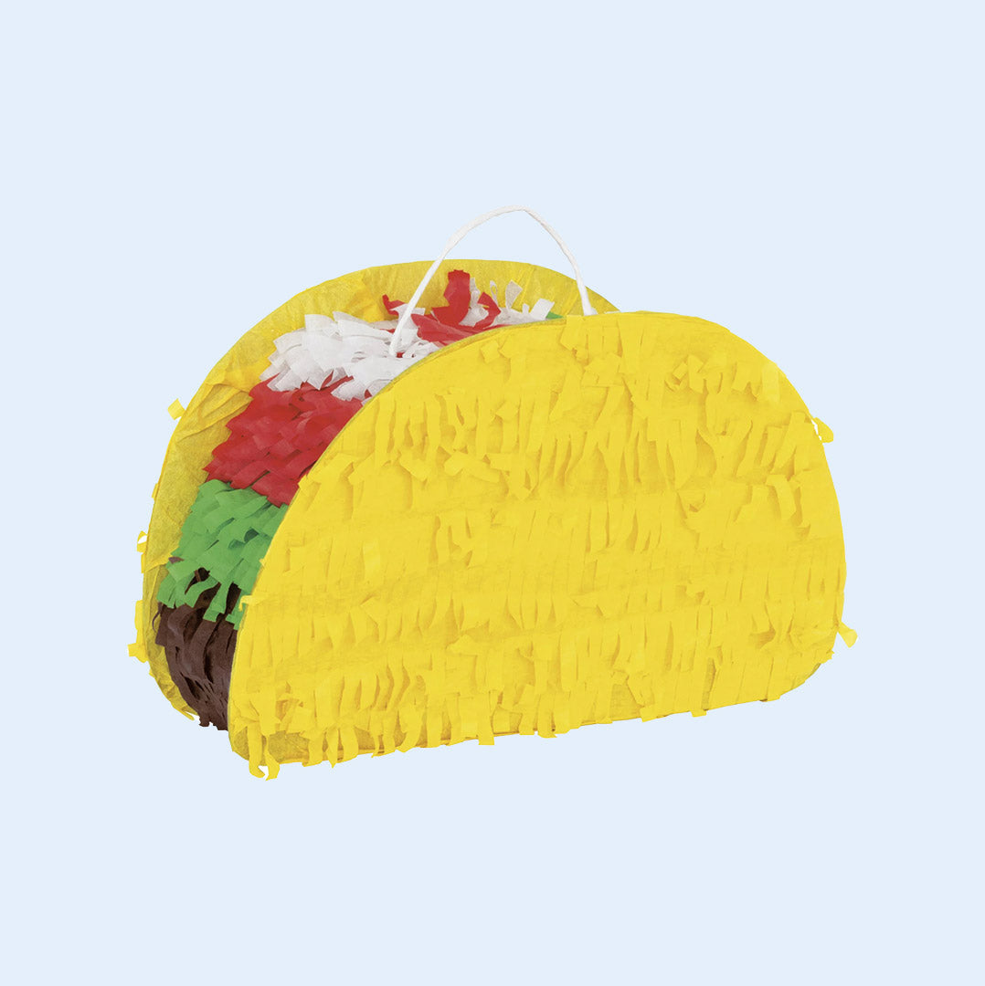 A taco-shaped bird piñata with a yellow shell and colorful fringe representing lettuce, tomato, and meat. Designed for parrots to shred, forage, and play. Perfect for bird enrichment activities. Available at Squawk Shop.