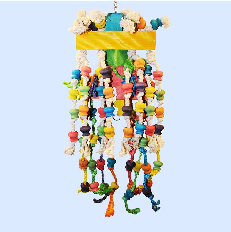 A large bird enrichment toy from Squawk Shop featuring hanging colorful ropes, wooden beads, and chewable wooden blocks for climbing, chewing, and preening fun.