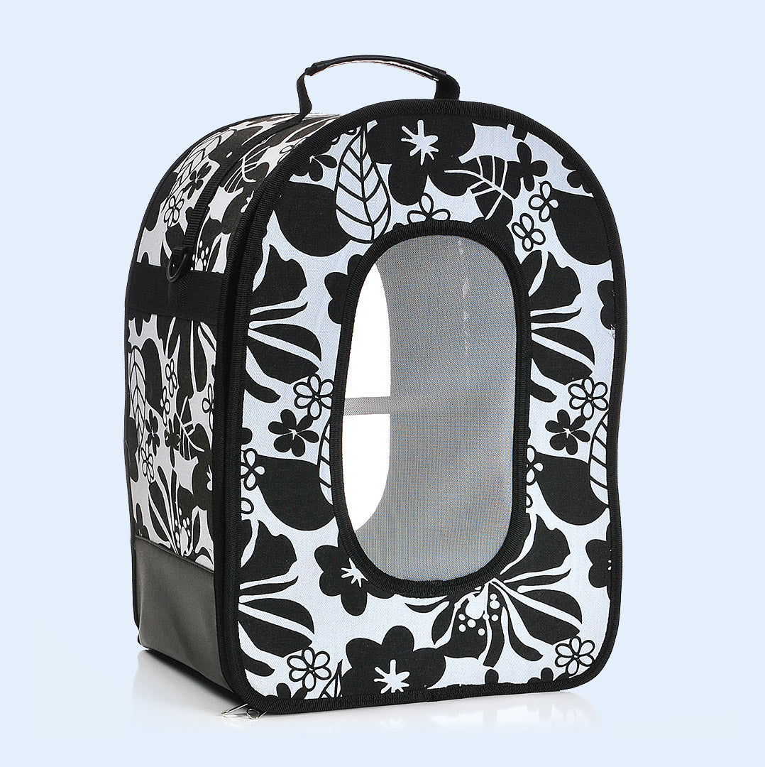 Large black travel carrier for birds from Squawk Shop featuring a stylish floral pattern, mesh window for ventilation, and a sturdy handle for easy transport. Ideal for parrots and other pet birds.