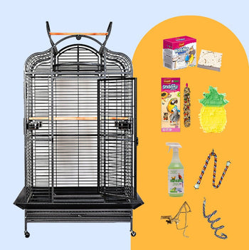 Black extra-large parrot cage with opening dome top and rolling stand, shown with the bundle's treats, toys and cleaner